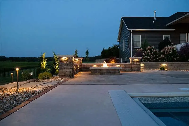 A large built in firepit on a modern patio designed by Knob Hill Landscape Company of Springfield, Illinois. 