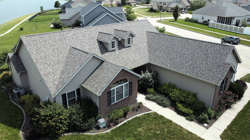 Aerial view of a residential home with a roof replacement by Copper Creek Contractors of Central Illinois.