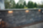 Retaining wall installation with lighting along a patio on a residential home. Designed and installed by Knob Hill Landscape Company of Springfield, Illinois.