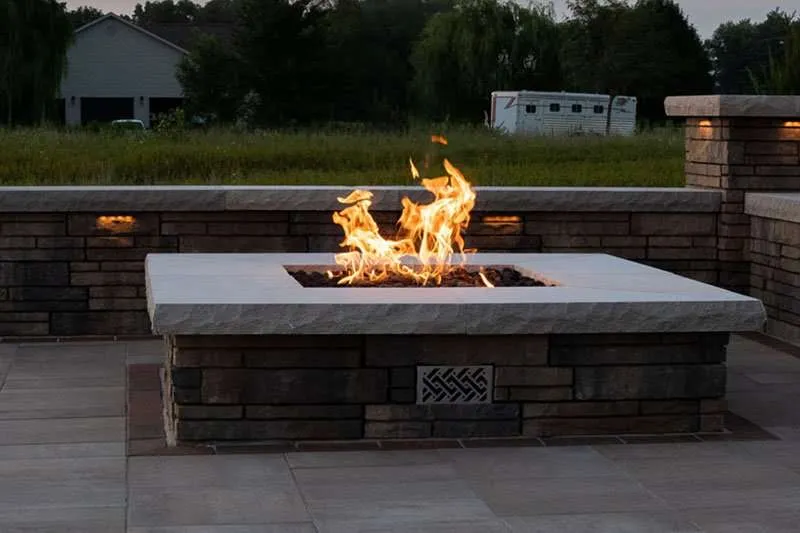 A large built in firepit on a modern patio designed by Knob Hill Landscape Company of Springfield, Illinois. 