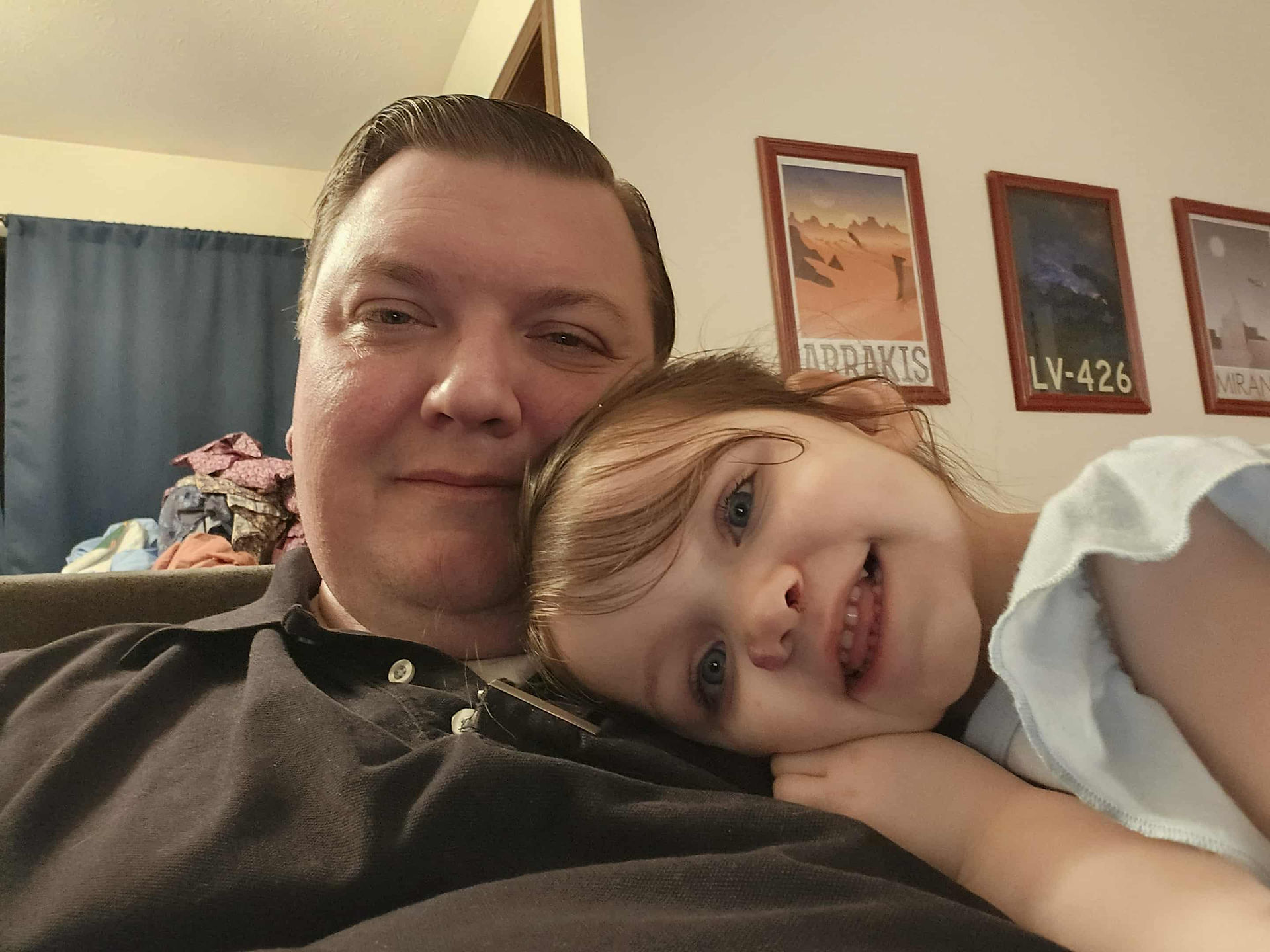 A little girl smiling with her father