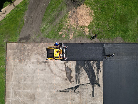 The Road Doctor employees repaving a Central Illinois basketball court
