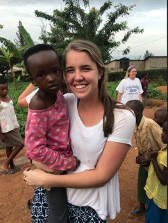 Susan holds young boy while on mission in Rwanda, Africa.