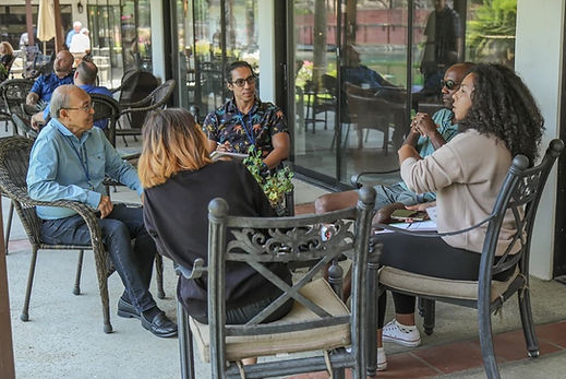 Five people sitting around a table