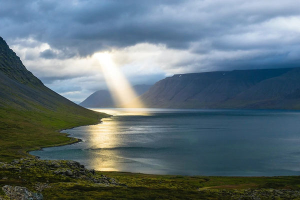 Lake with beam of light hitting it from sky