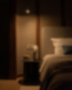 Bedroom with bedside lamp in evening light