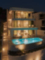 Beleuchtete dreigeschossige Villa am Meer mit Infinity-Pool bei Nacht, Trogir Riviera
