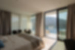 Principal bedroom with sliding glass doors and sea-view balcony