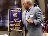 Man presenting 'The Four-Way Test' principles