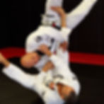 Nick Thomas and Pedro Pacheco Fernandes perform a jiu jitsu move.
