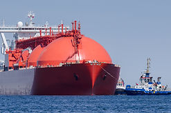 LNG TANKER - The red ship enters port wi