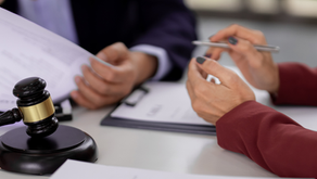 Chicago attorney reviewing post-judgment collection documents with client.