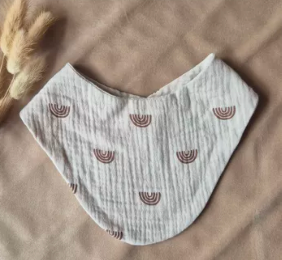 White baby bib with rainbow design