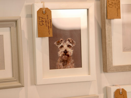 A framed terrier image in white frame