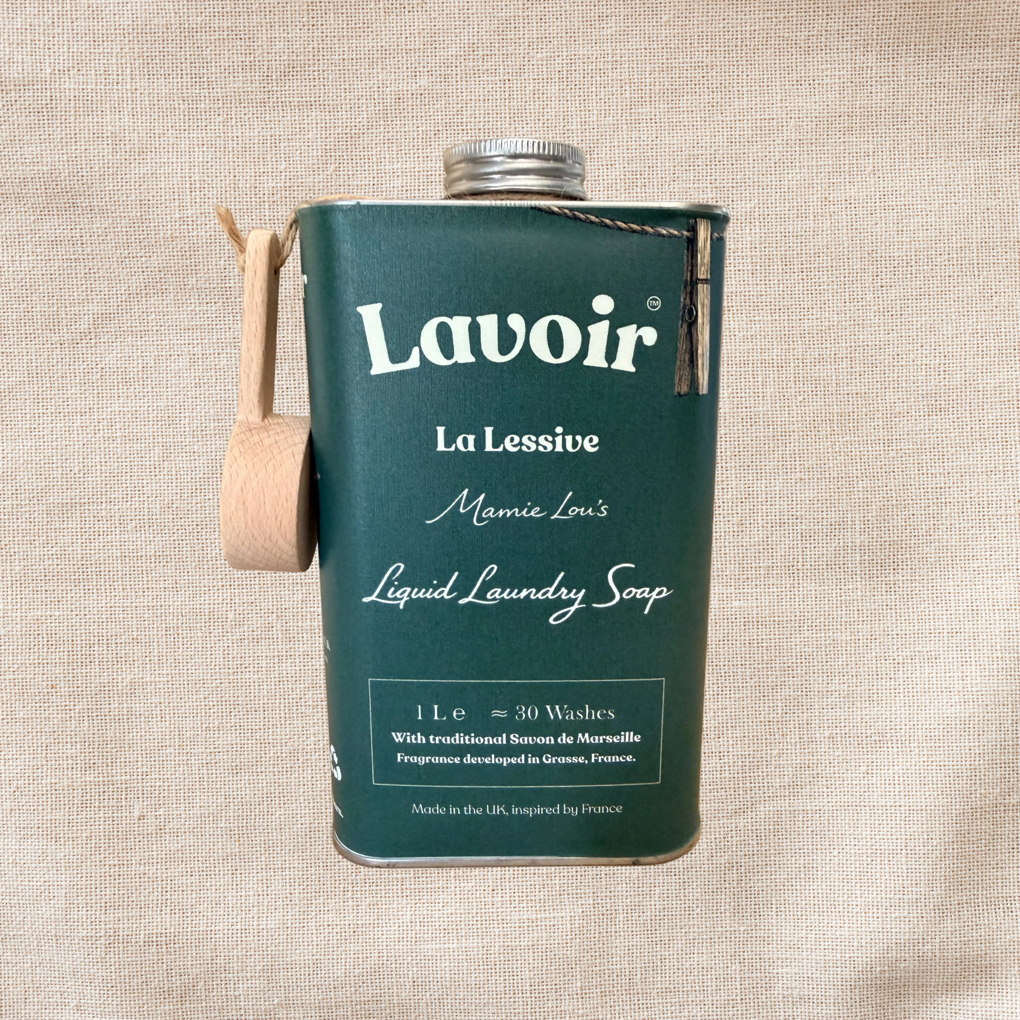 Wooden scoop and tin containing Lavoir liquid laundry soap