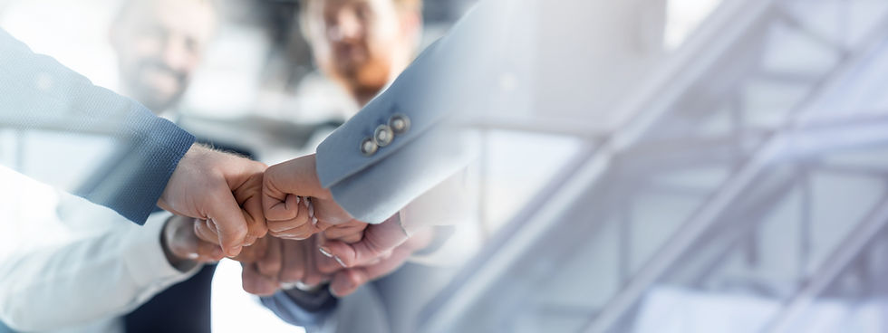 Cropped of a business teams hands clasped together in a fist bump, showcasing their camara