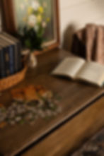 Styled reading corner with open book, vintage accessories, and cozy ambient lighting