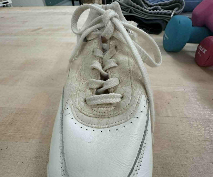 Close-up of Brook Aleksic’s white sneaker on a therapy platform.