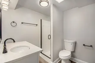 Renovated guest bath with new fixtures and vanity
