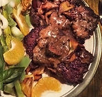 Air fryed cube steak topped with a savory sauce and served with a salad
