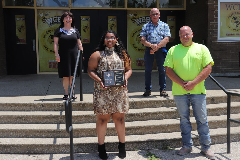 MAQUOIA BERNABE was presented with the Michael Jackson “Trailblazer” Award July 10. Pictured from left are Debbie Jackson, Bernabe, Randy Cotton and Coach Brent Courtney. (Photo by Thomas Mims)