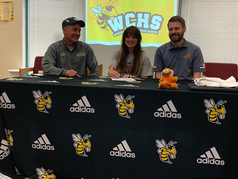 Cutline: WCHS SENIOR ESTHER BRADSHAW (center) committed to Georgetown College Tuesday afternoon. She’ll be the third WCHS product on the Georgetown roster for 2019-2020. WCHS Assistant Coach Michael Gormley (left) and Georgetown coach Luke Garnett (right) were in attendance. (Photo by Thomas Mims)