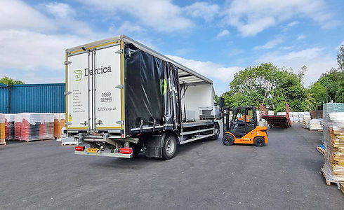 Forklift loading an Oxford Plastics haulage truck.