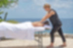 lady having a massage with the sea in the background