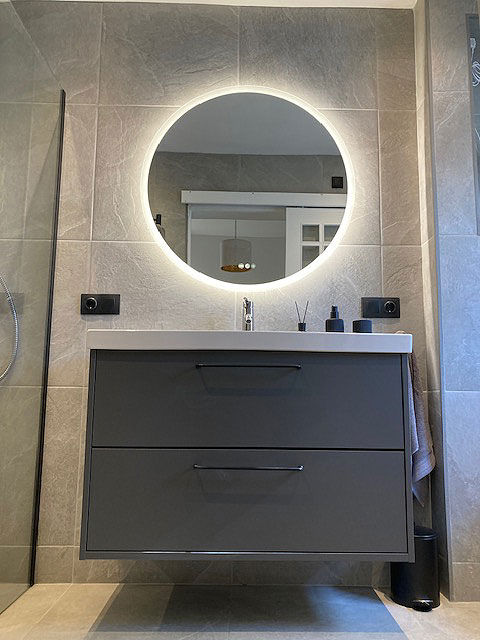 Floating dark grey vanity with round backlit mirror
