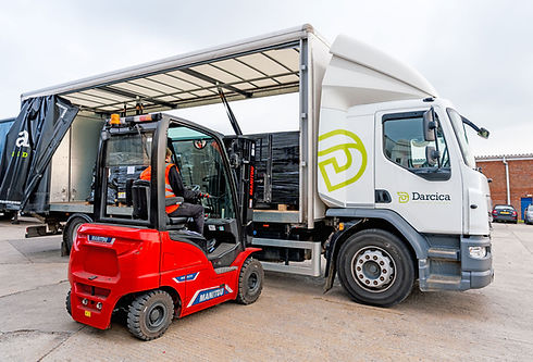 Forklift loading goods into a branded delivery truck