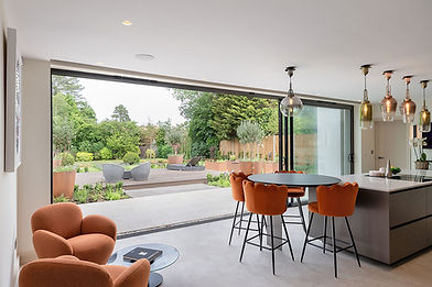 Modern open-plan living space with large glass doors to garden