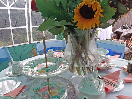 Dining table set with sunflowers and serving dishes