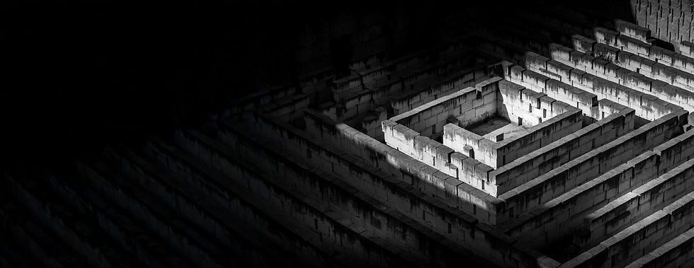 High-angle view of a stone labyrinth at night.