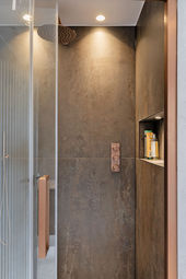 Contemporary shower with glass door and tiled walls