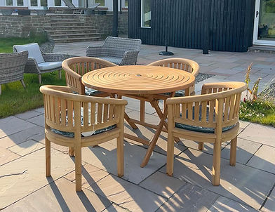 Outdoor wooden dining set on stone patio