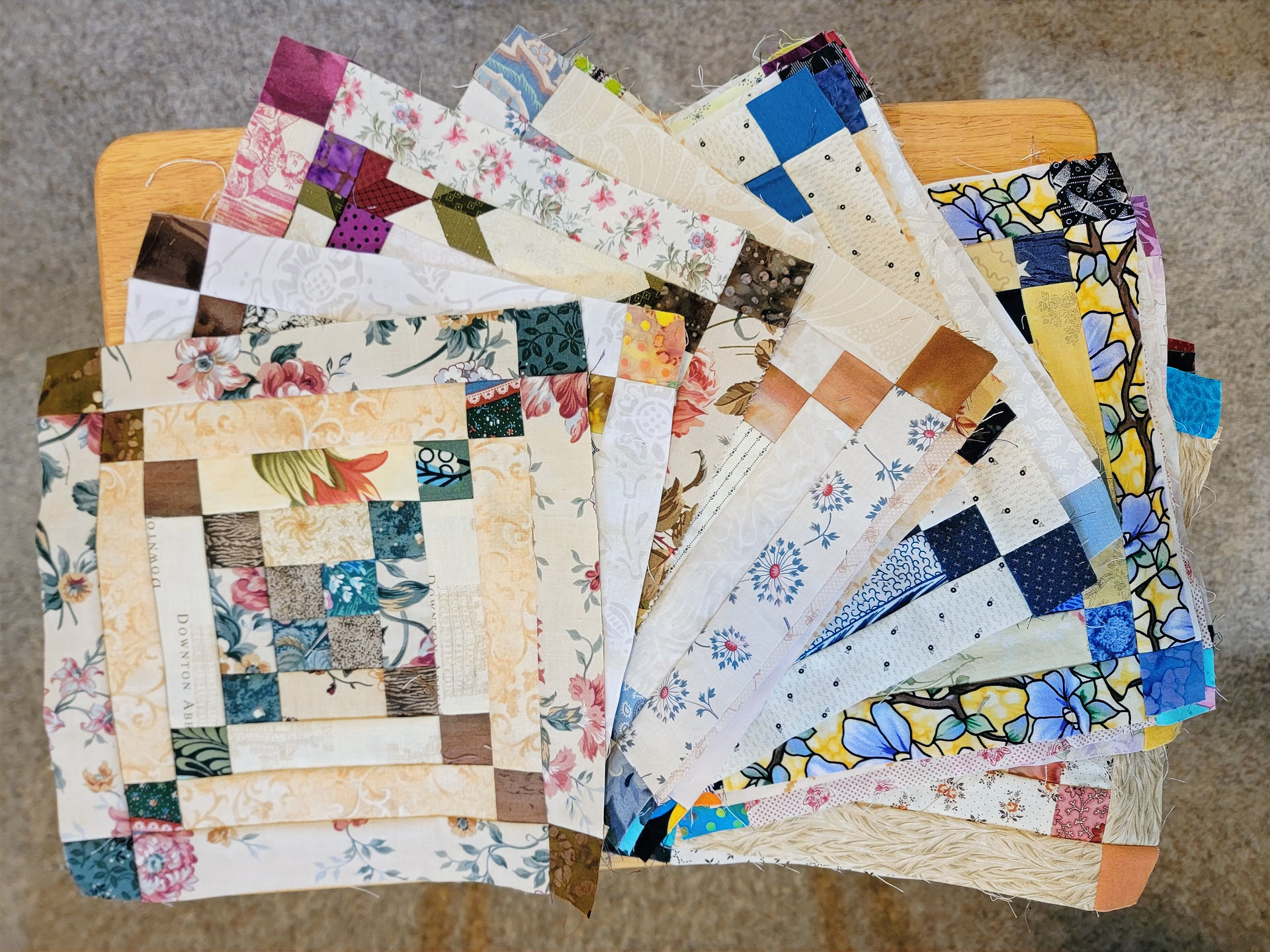 A selection of square quilt blocks in a variety of colours and patterns
