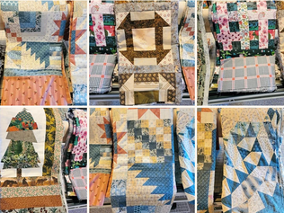 A selection of quilt tops in a variety of colours and patterns