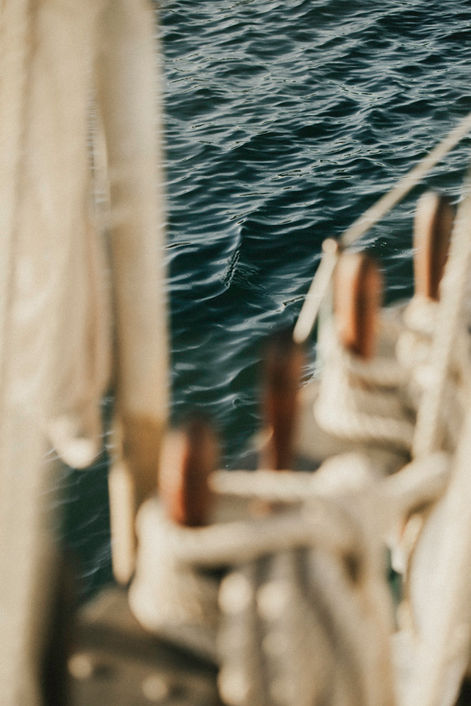 Abstract artistic view of dark water texture with blurred ship rigging and rope details from aboard tall ship Irving Johnson in Los Angeles Harbor