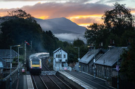 Dawn in the Scottish Highlands. The sun rising over the mountains to the south of Blair Atholl, is timed to perfection with this HST departure to Glasgow.
