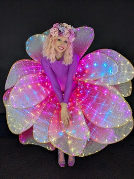 Model wearing LED flower costume with black background