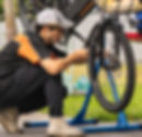 Close-up view of a certified bike technician adjusting a bicycle brake system