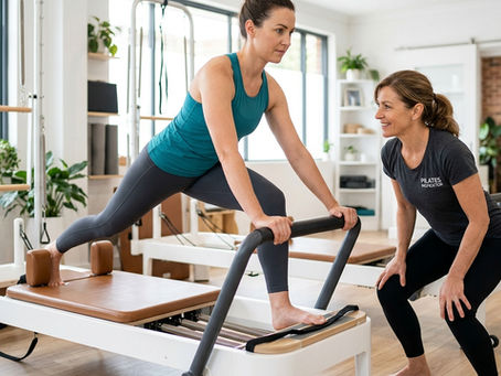 Pilates instructor analysing muscle recruitment during Reformer strength training.
