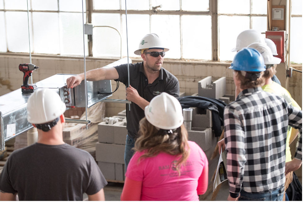 Students work on a mechanical ductwork rough-in assembly to gain hands-on experience with duct connections, supports, VAV systems, and mechanical layout.