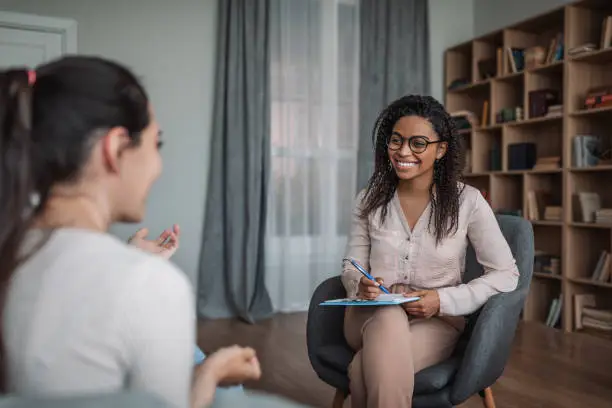 Two individuals engaged in therapy session