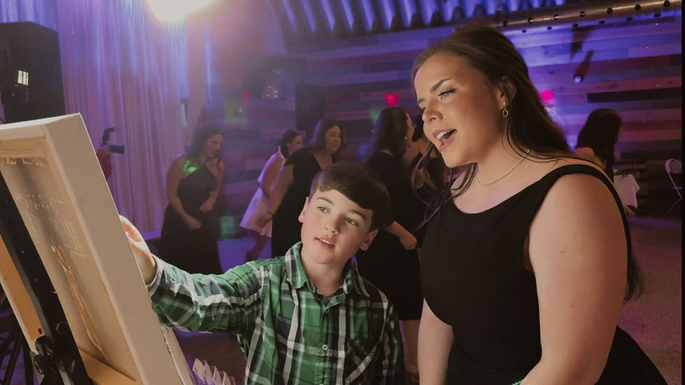 Kid helping with a painting during wedding celebration.