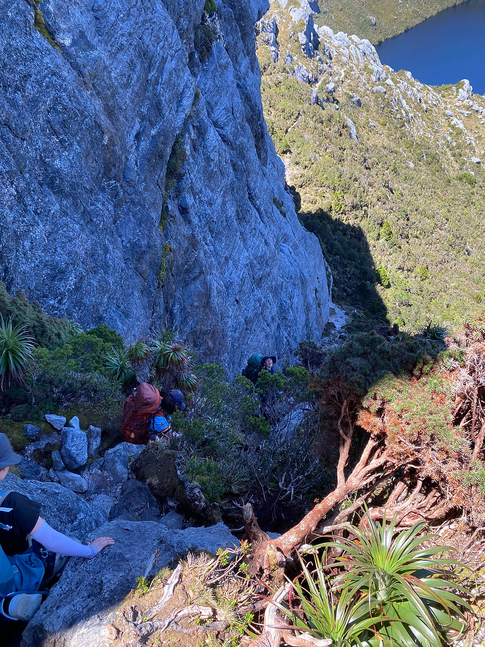 People climbing down a very steep descent