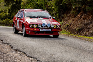 a red car with the number 222 on the windshield