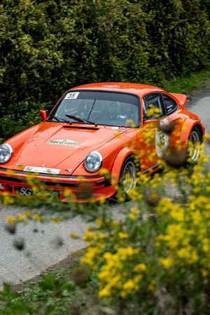 an orange car with the number 35 on the windshield