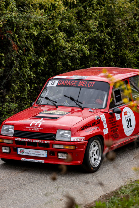 a red car with the number 32 on the windshield
