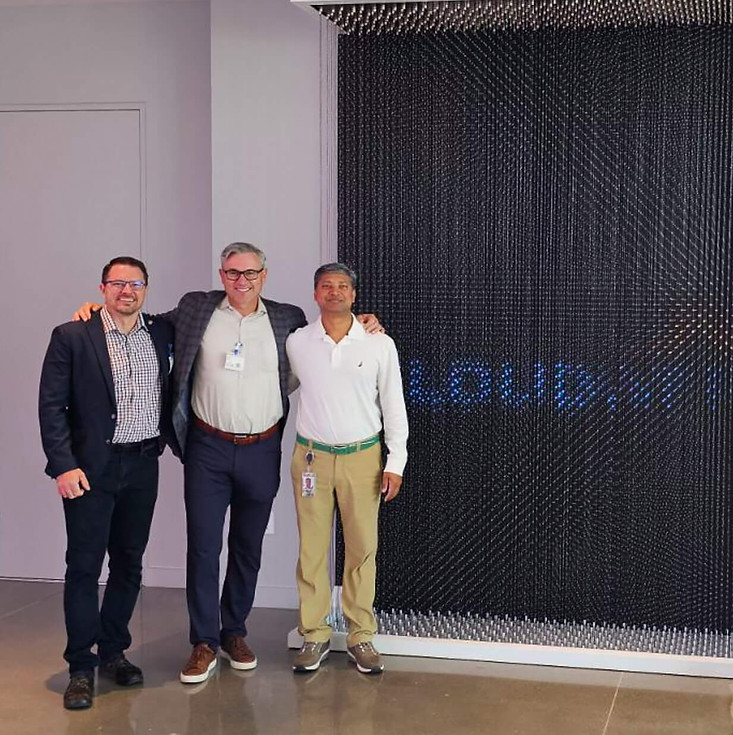 CloudWerx team members in front of CloudWerx display